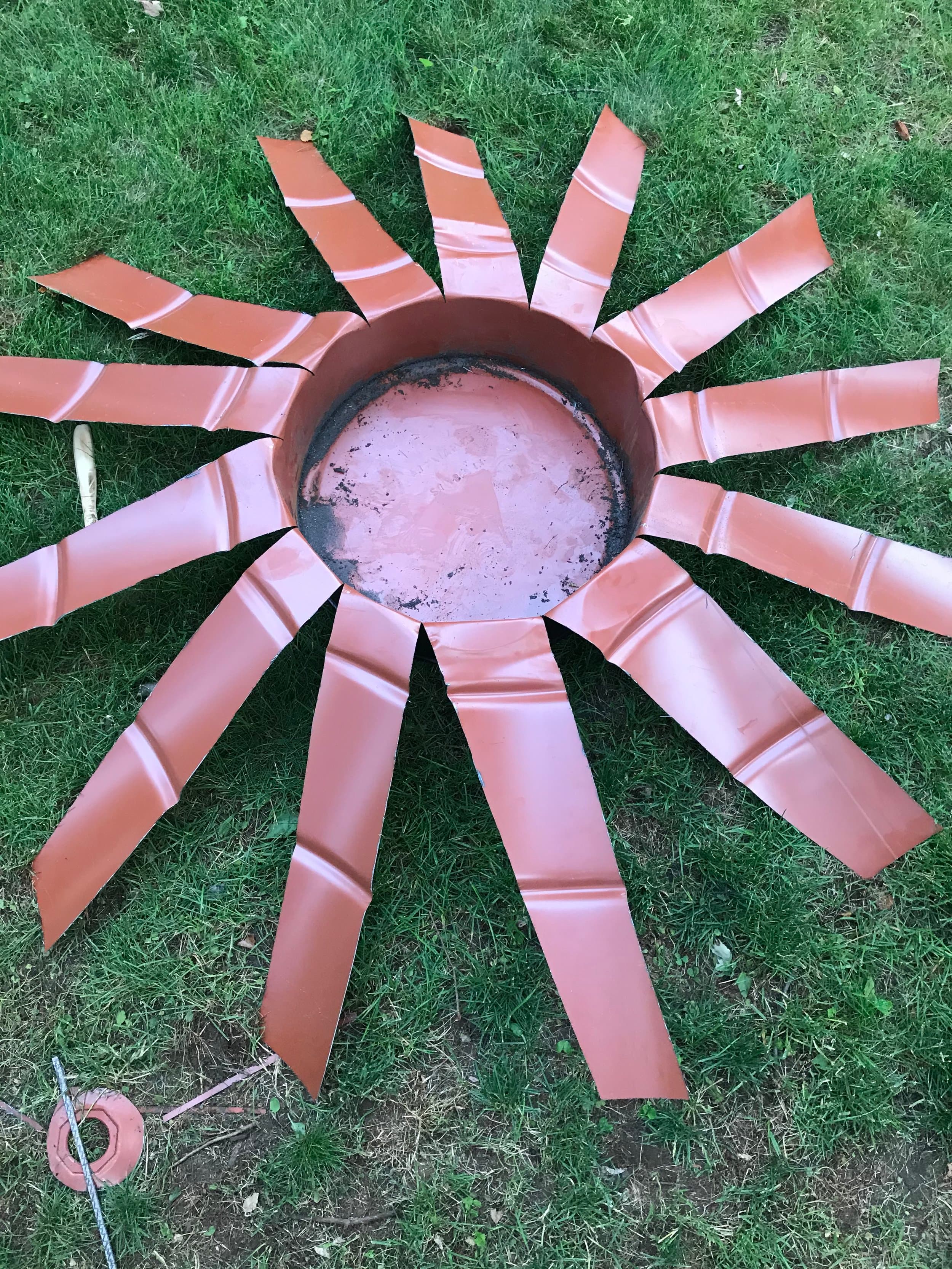 The idea here was based on a trick we used to do with disposable plastic cups to turn them into a flower. Except with thick and sharp metal. What could go wrong?