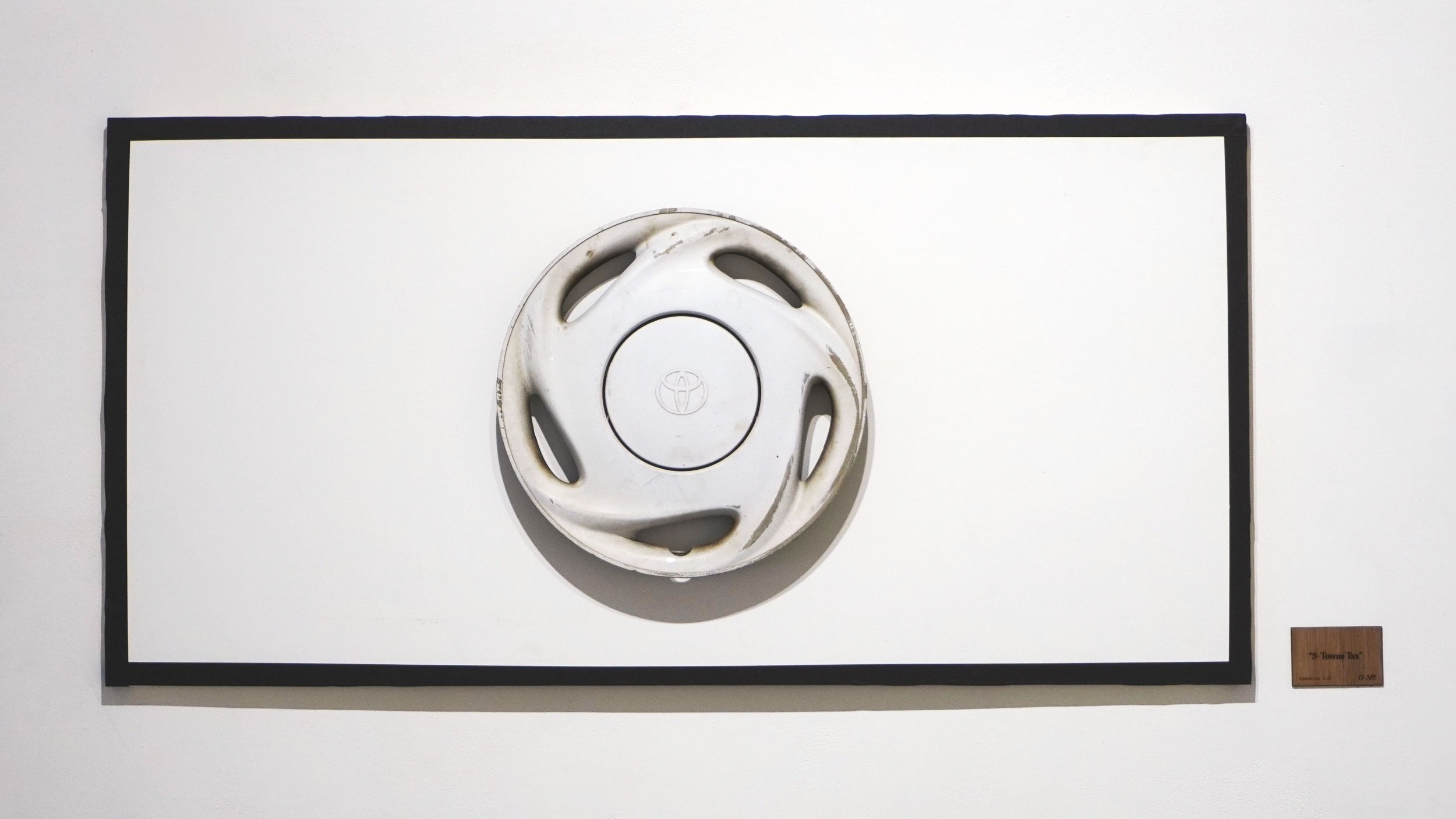 “Five Towns Tax” - 1999 Toyota Corolla hubcap