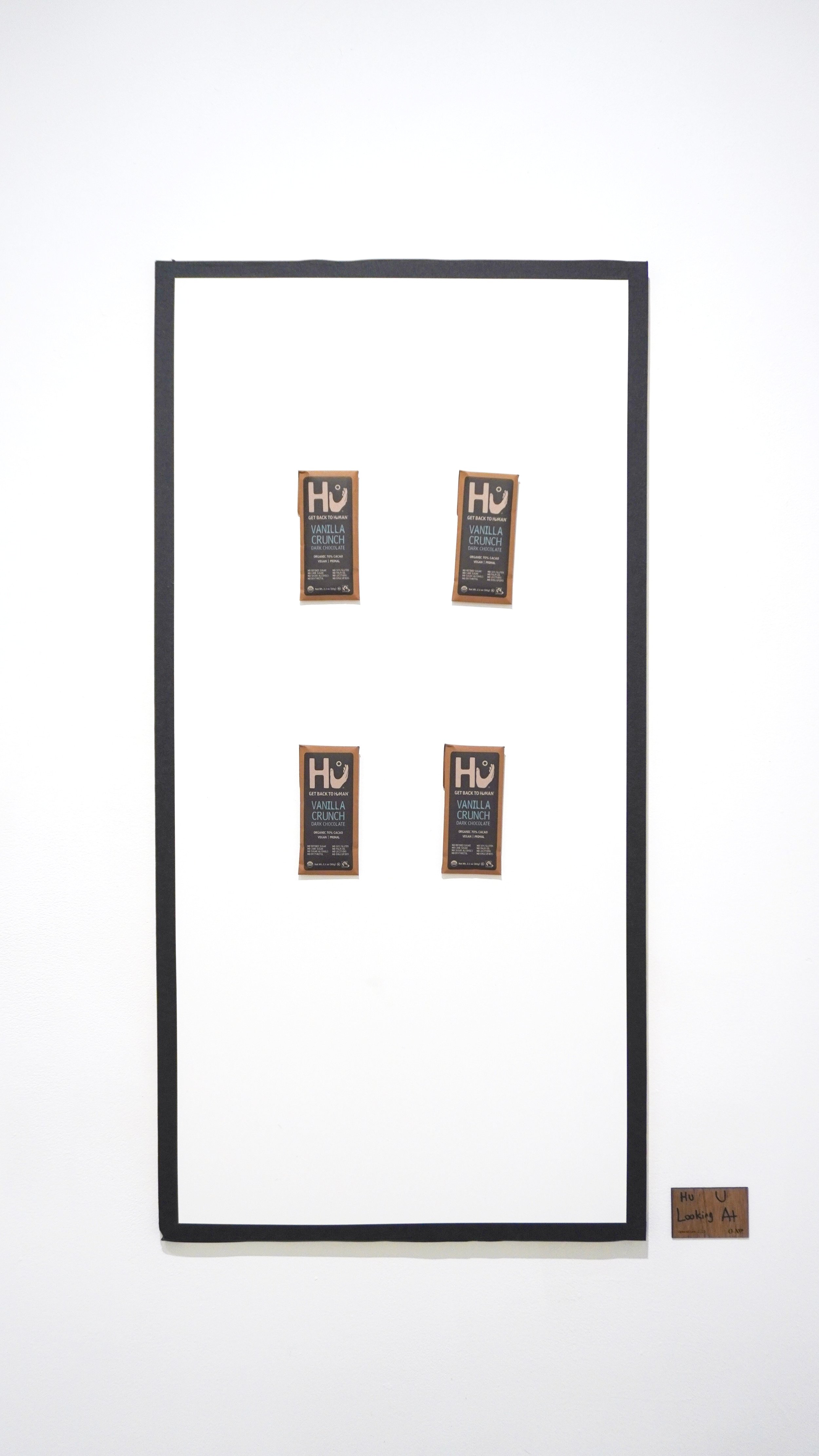 “Hu U Looking At” - chocolate bars on a white panel