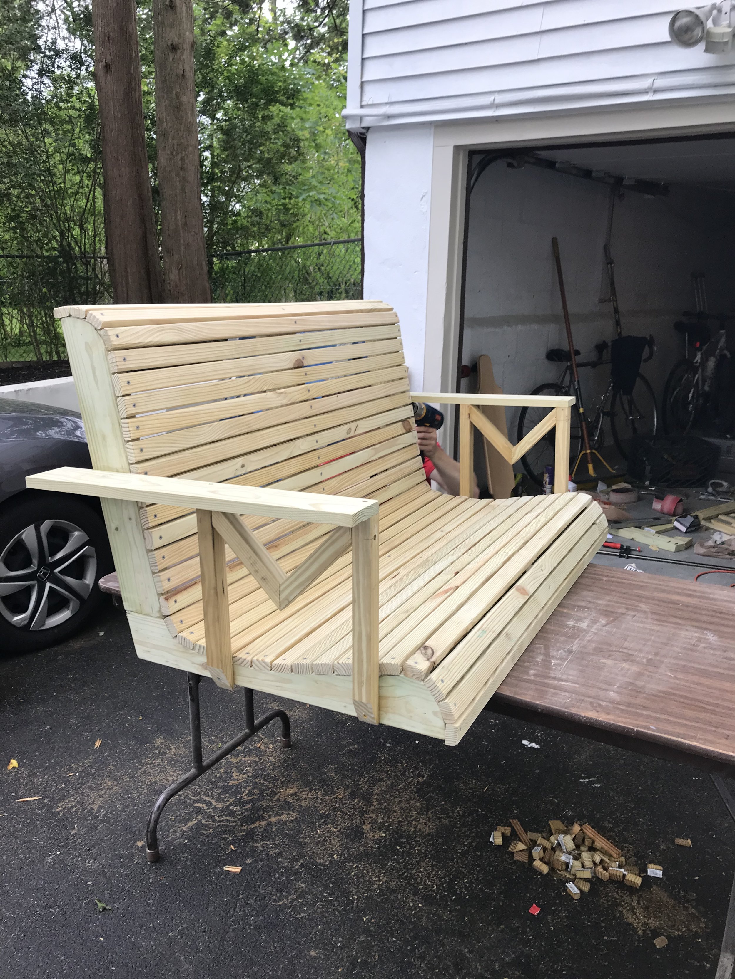Slats installed and trimmed, armrests attached. All that was left was to angle off the armrests, install eye bolts, and bore a hole through each armrest for the chain to pass through. Plus of course finishing (sanding, staining, poly).