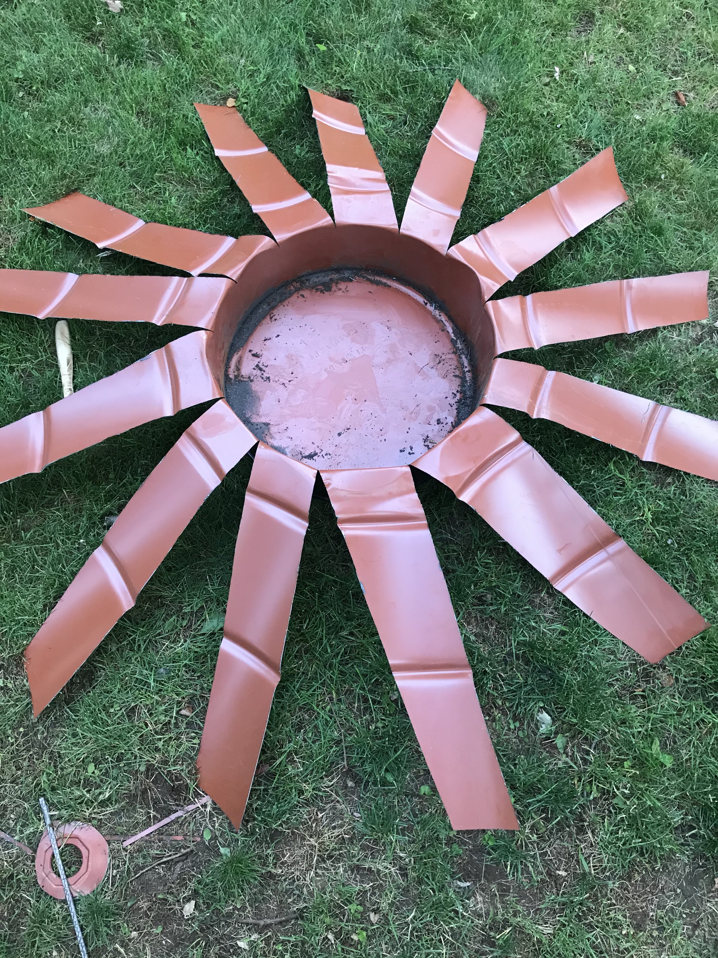 The idea here was based on a trick we used to do with disposable plastic cups to turn them into a flower. Except with thick and sharp metal. What could go wrong?